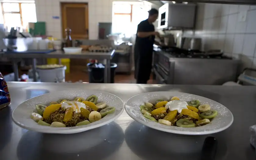 Neighbours sharing food at a community table